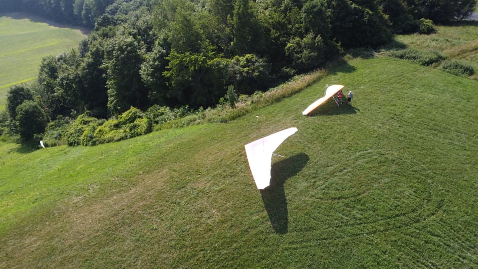 Hang glider launching into the valley