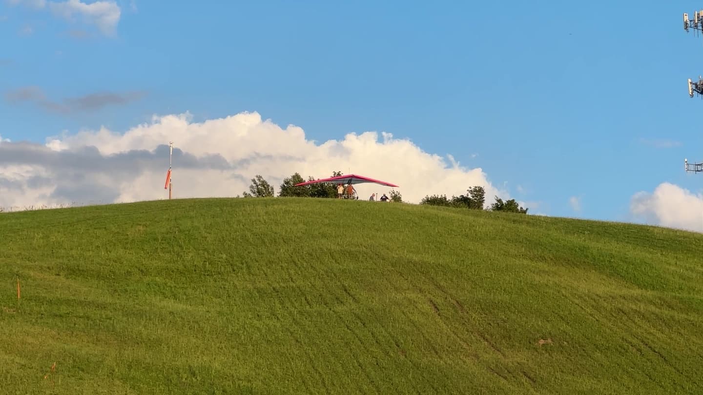 A student handling a hang glider at Padgham Hill